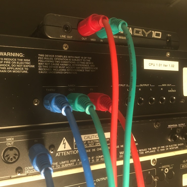 Red, blue, and green MIDI cables in use