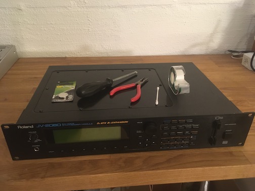 Photo of a Roland JV-2080 sound module and some tools